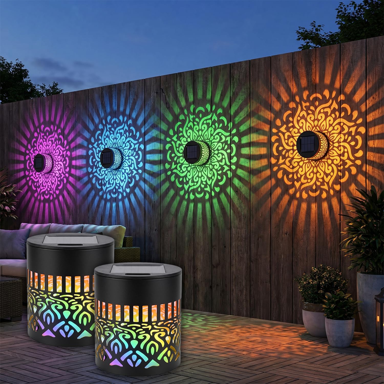 Metal solar mandala wall light projecting a color-changing pattern onto a fence